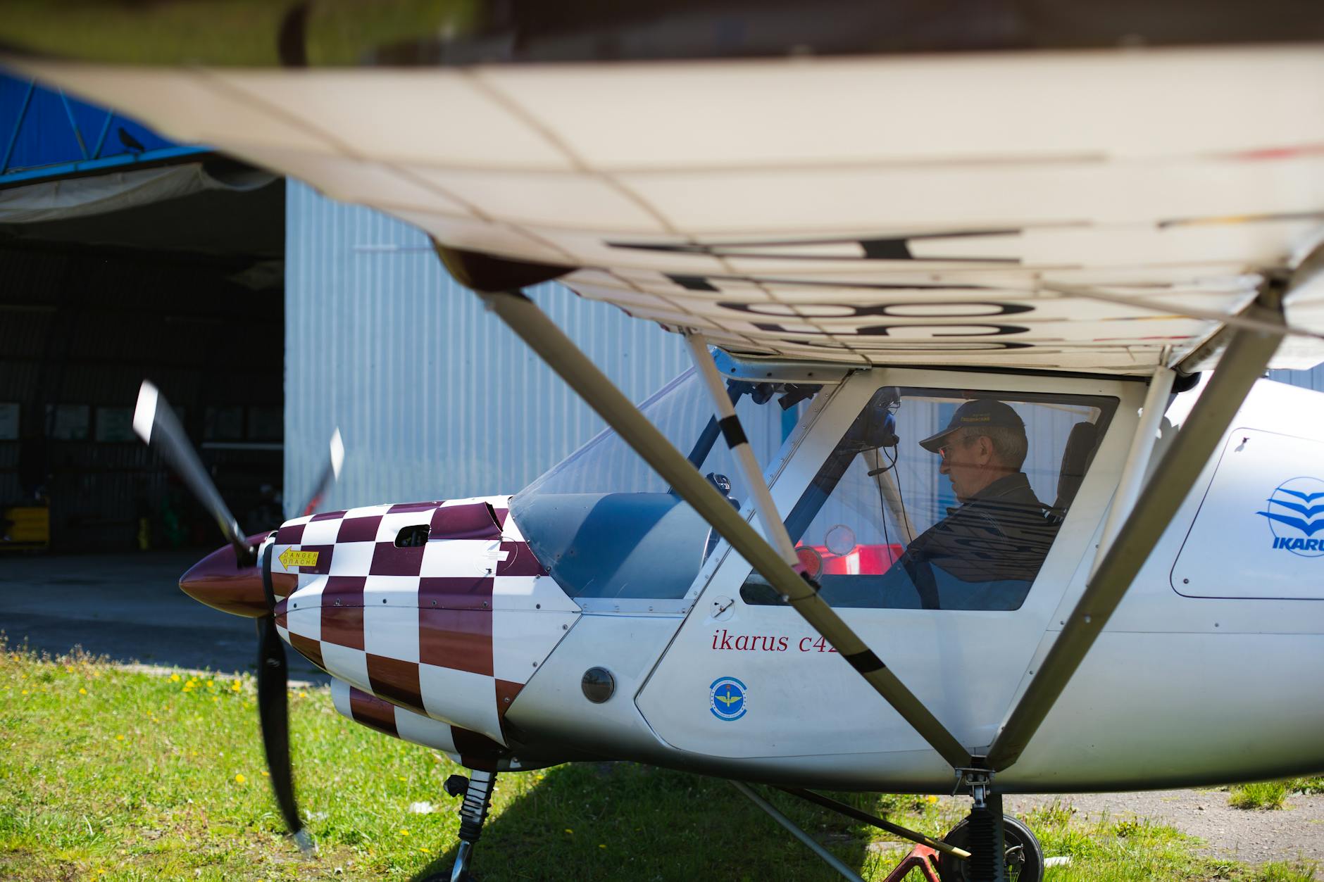 photo of a pilot in a white and red airplane