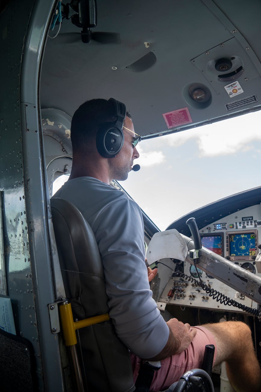 a man sitting in the cockpit of a small plane