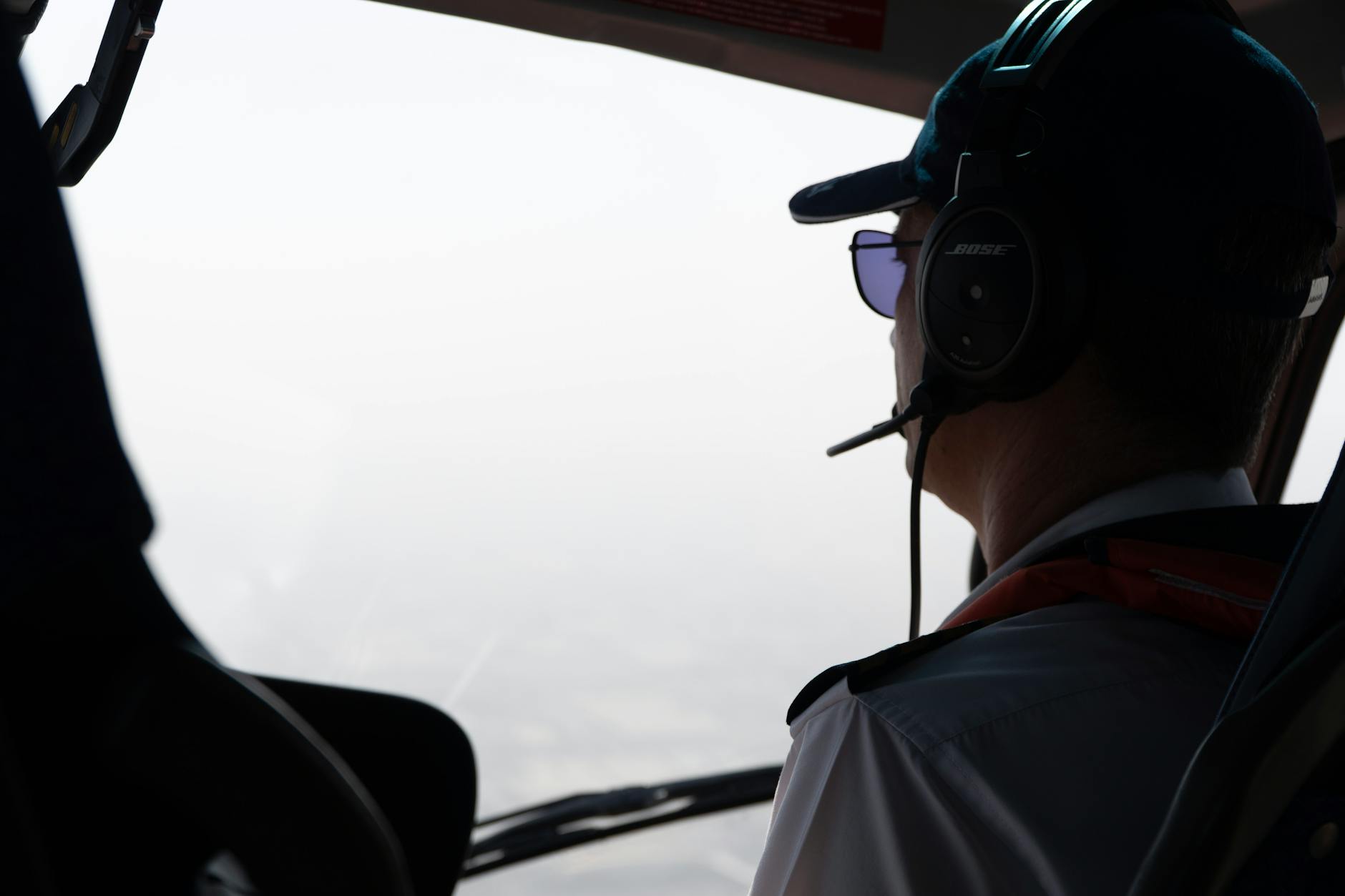 pilot flying in aircraft cockpit with headset