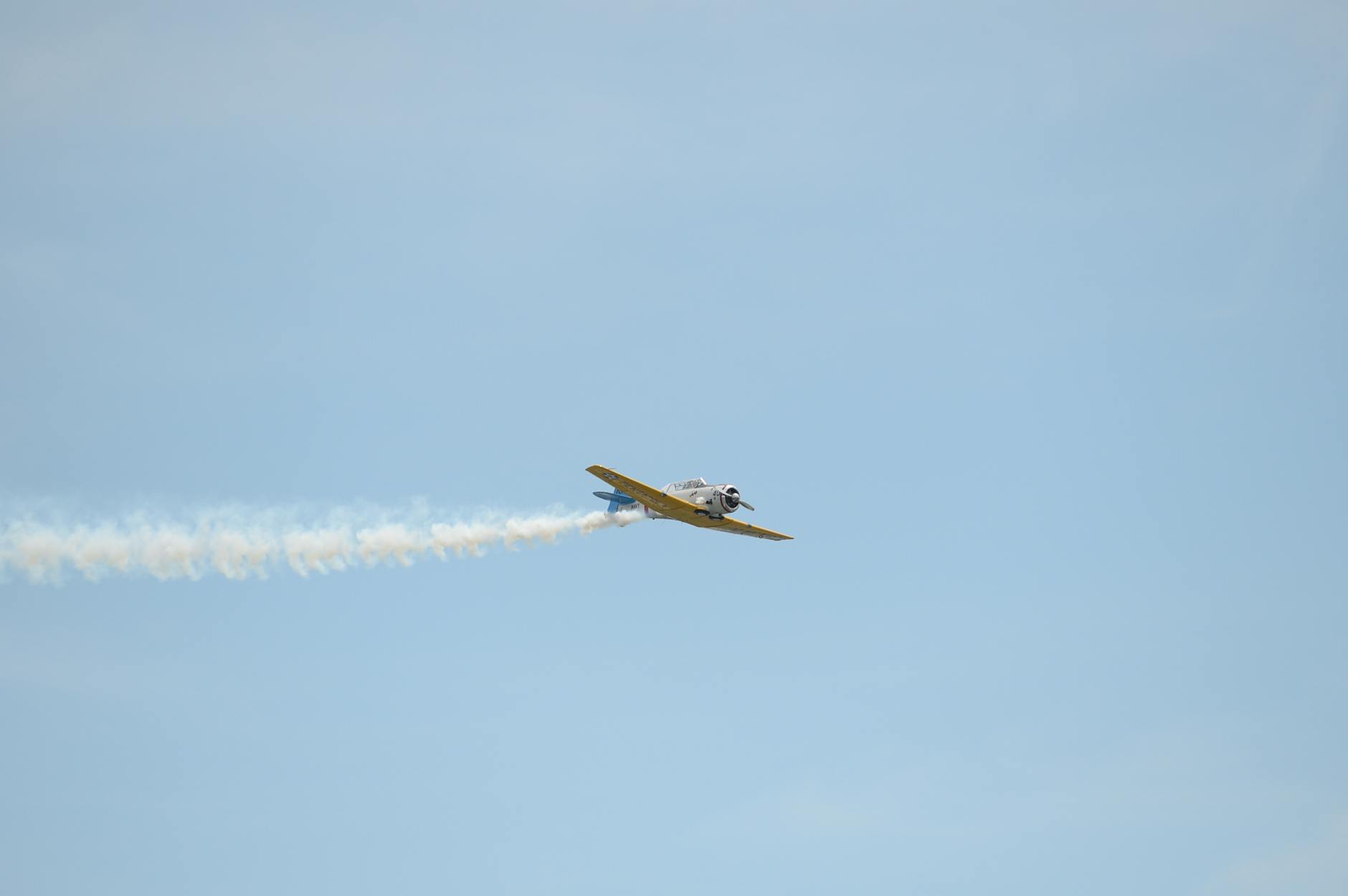 yellow airplane in mid air