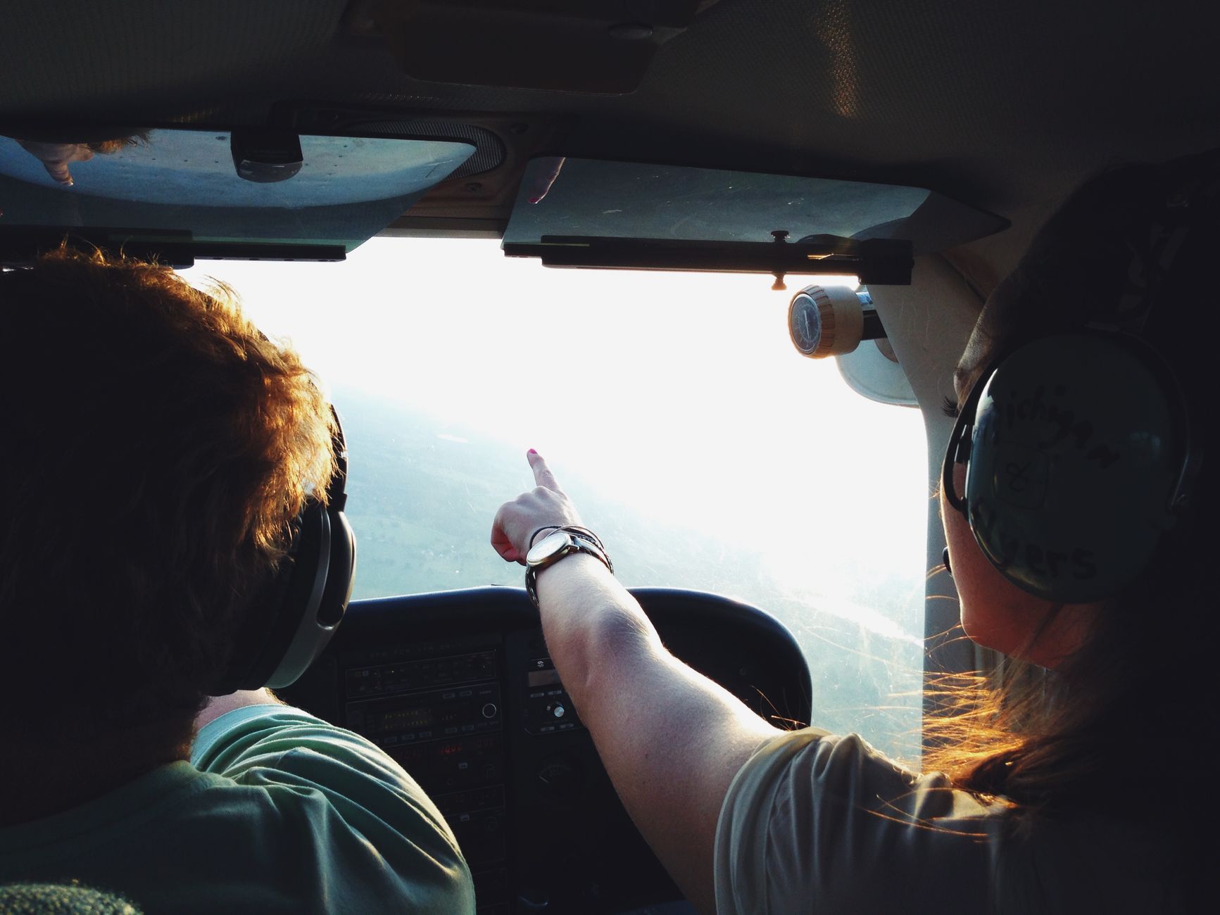 persons on aircraft pointing on view during daytime