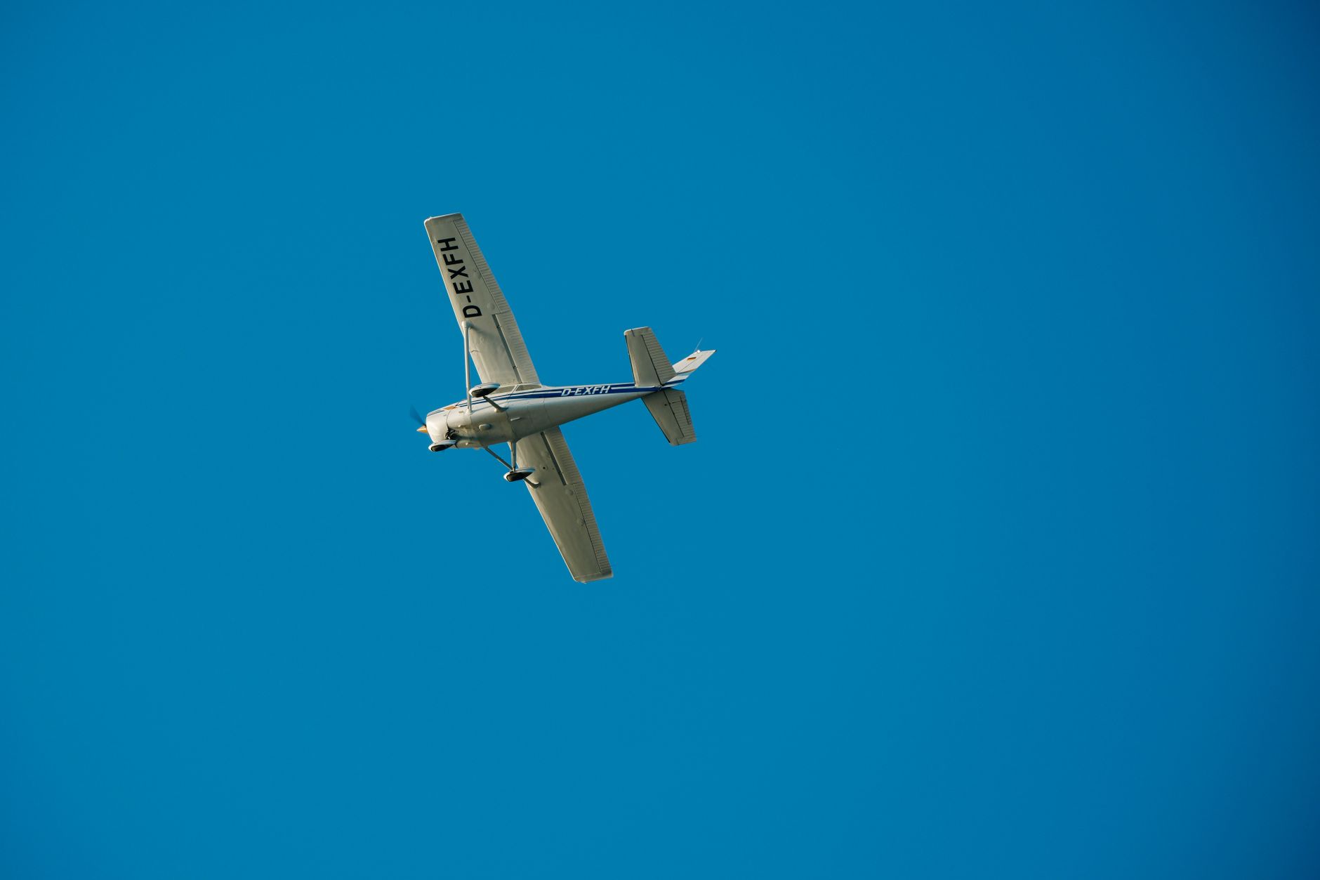 light aircraft flying in clear blue sky