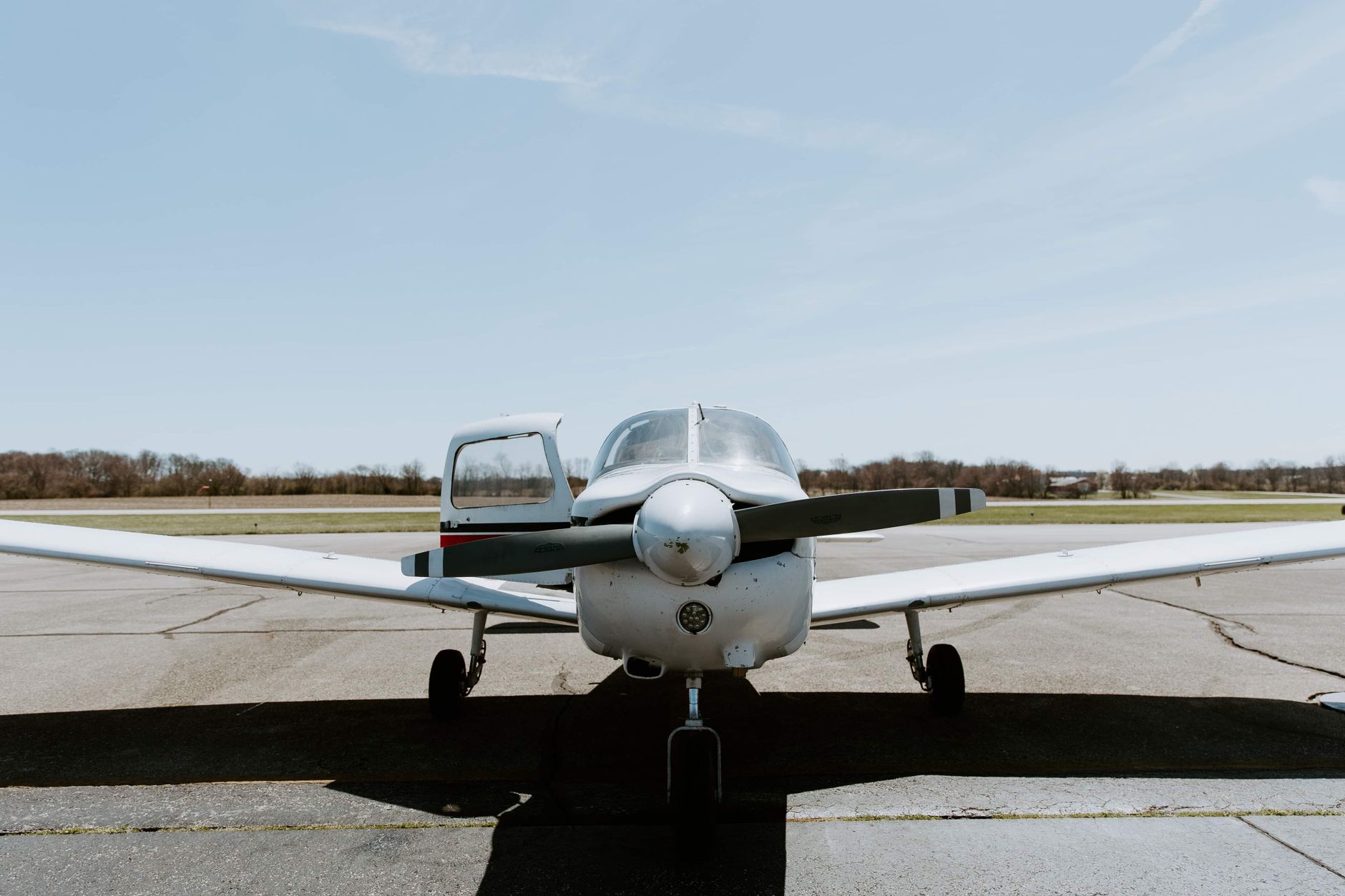 airplane on runway under blue sky