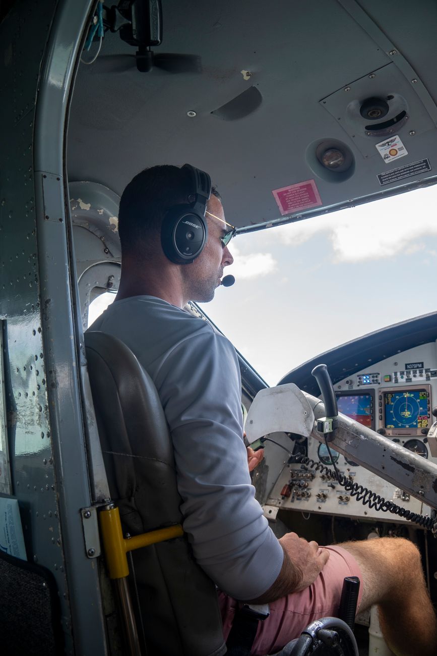 a man sitting in the cockpit of a small plane