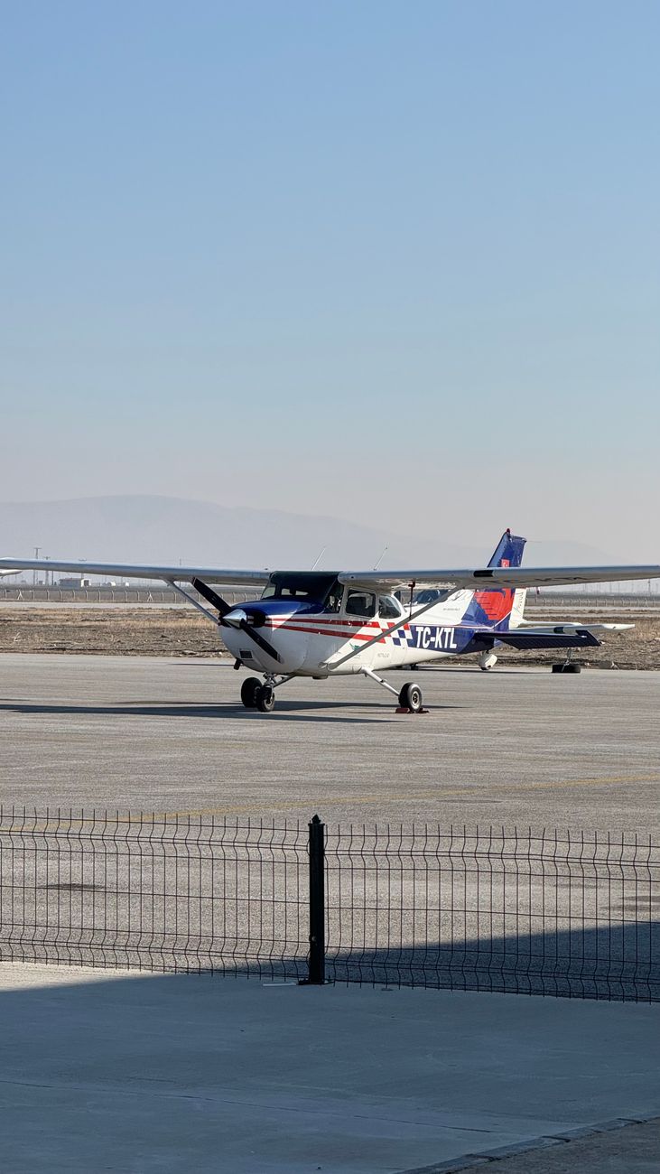 small cessna aircraft on a sunny airfield