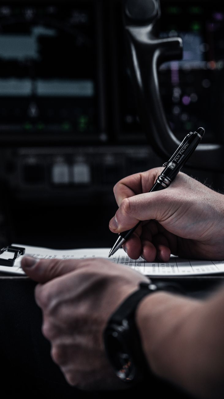 pilot completing paperwork in aircraft cockpit