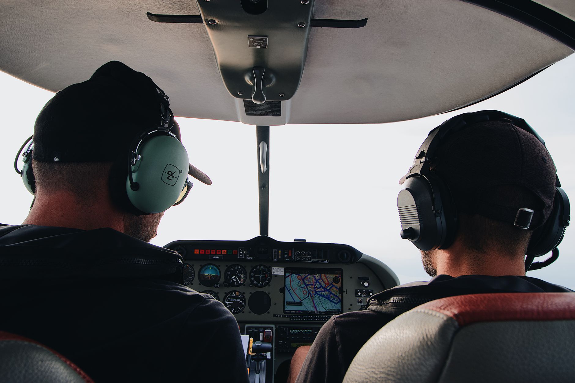 two men sitting inside helicopter