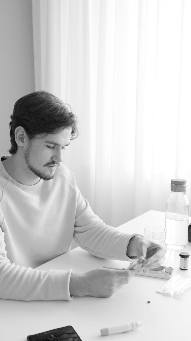man in crew neck long sleeve shirt checking his glucose blood level